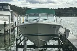Slide: The Image of 1997 Limestone 24 Cuddy boat docked on a lift by the water. - 3