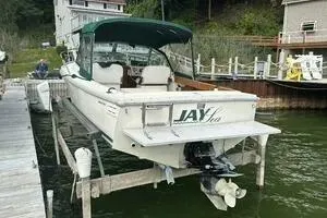 Slide: The Image of 1997 Limestone 24 Cuddy boat docked at a lakeside pier. - 5