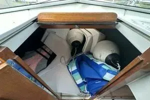 Slide: The Image of 1997 Limestone 24 Cuddy cabin interior with storage items and nautical equipment. - 7