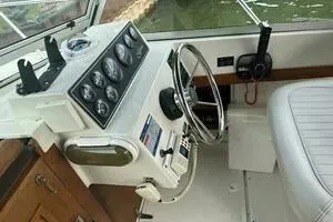 Slide: The Image of 1997 Limestone 24 Cuddy boat cockpit with steering wheel and instrument panel. - 8