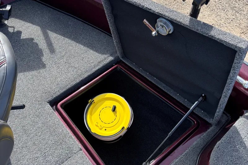 Slide: The Image of 2021 Tracker Nitro ZV21 boat storage compartment with yellow bucket inside. - 11