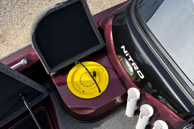 Slide: The Image of 2021 Tracker Nitro ZV21 boat interior with storage compartments and rod holders. - 14