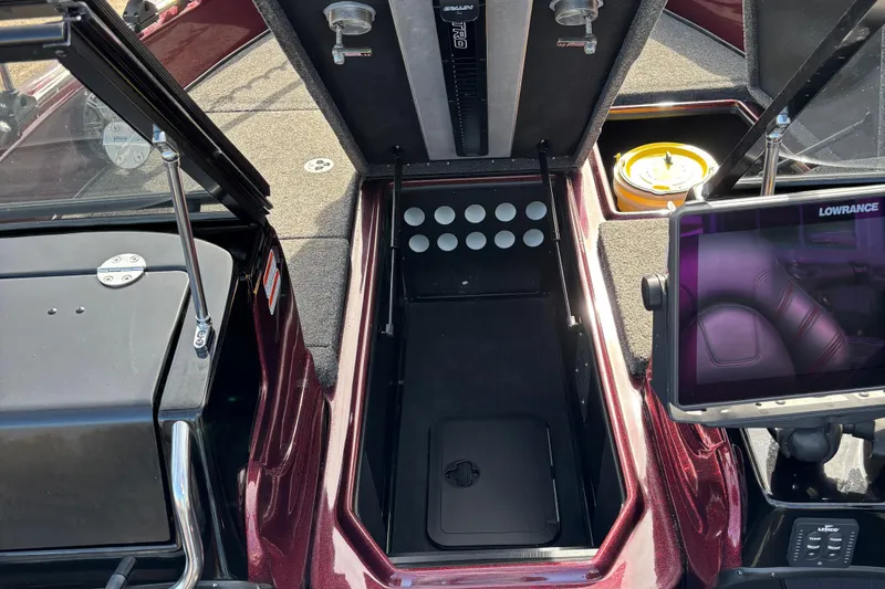 Slide: The Image of 2021 Tracker Nitro ZV21 boat interior with storage compartment and Lowrance display. - 16
