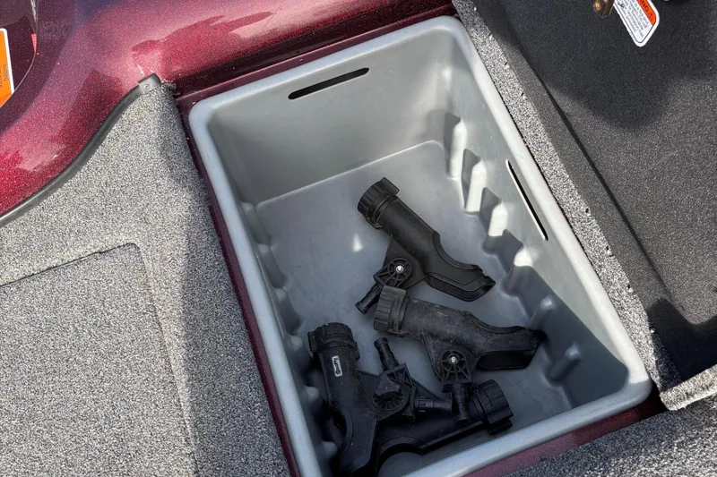 Slide: The Image of Storage compartment in 2021 Tracker Nitro ZV21 boat with black accessories inside. - 17
