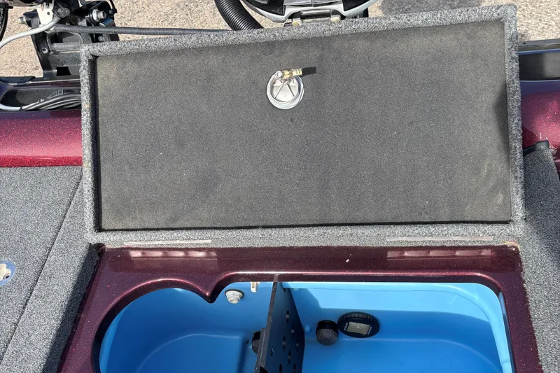 Slide: The Image of 2021 Tracker Nitro ZV21 boat compartment with open lid, revealing interior storage space. - 18