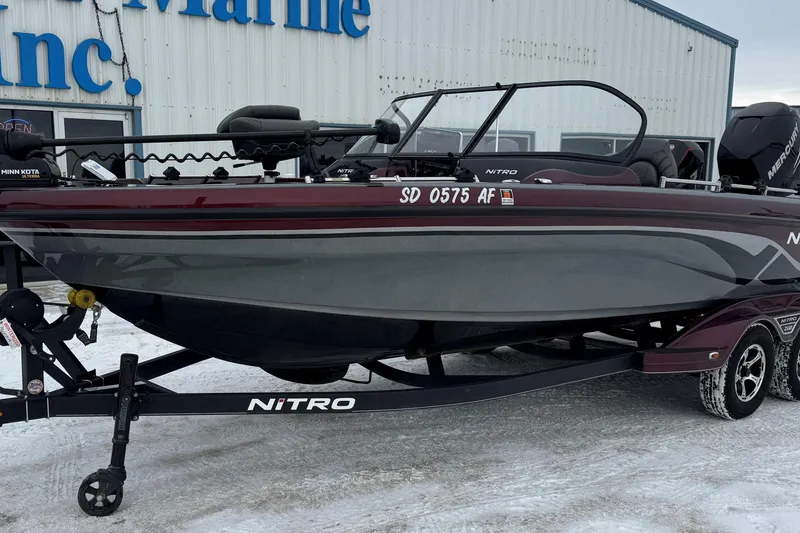 Slide: The Image of 2021 Nitro ZV21 boat on trailer, parked outside a marine dealership in snowy conditions. - 26