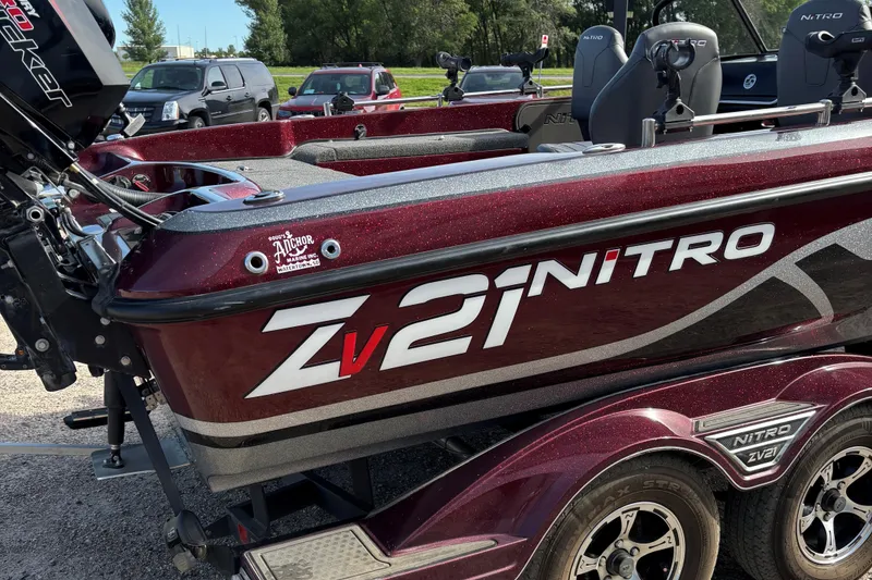 Slide: The Image of 2021 Tracker Nitro ZV21 boat with maroon finish, parked on a trailer. - 3