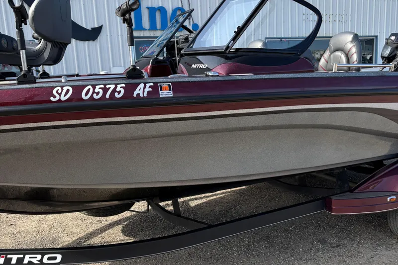 Slide: The Image of 2021 Tracker Nitro ZV21 boat with registration SD 0575 AF, parked outdoors. - 6