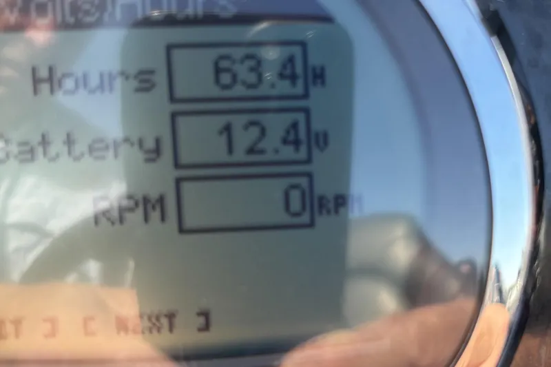 Slide: The Image of Close-up of 2021 Tracker Nitro ZV21 display showing 63.4 hours, 12.4V battery, 0 RPM. - 8