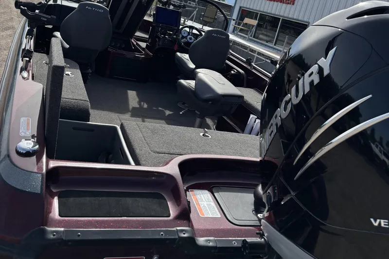 Slide: The Image of 2021 Tracker Nitro ZV21 boat interior with Mercury engine, featuring seating and control console. - 9