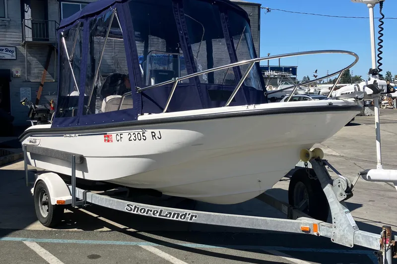 Slide: The Image of 2002 Boston Whaler 160 Dauntless boat on trailer with blue canopy. - 4