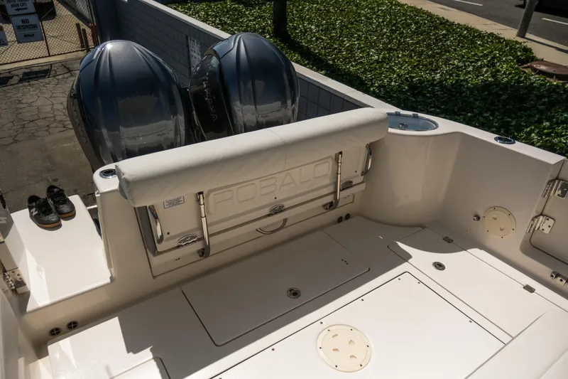 Slide: The Image of 2023 Robalo R302 Center Console boat with dual engines, rear seating, and spacious deck. - 10