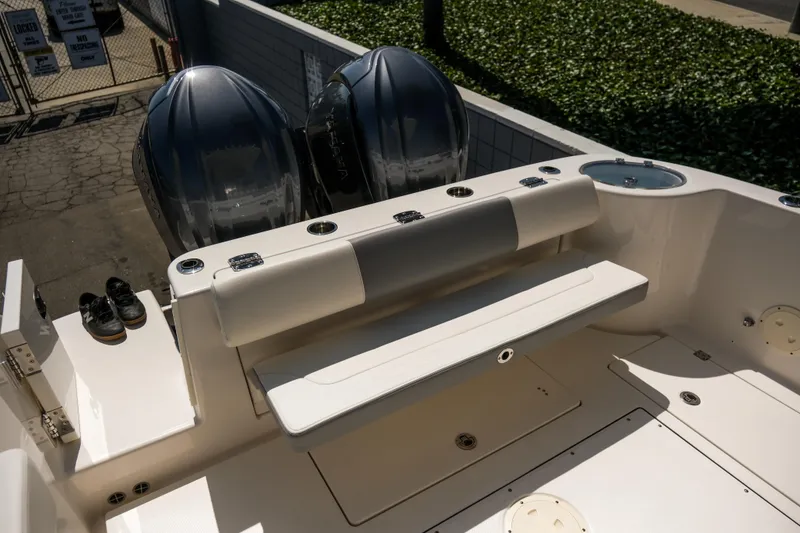 Slide: The Image of 2023 Robalo R302 Center Console boat with dual engines and seating area. - 11