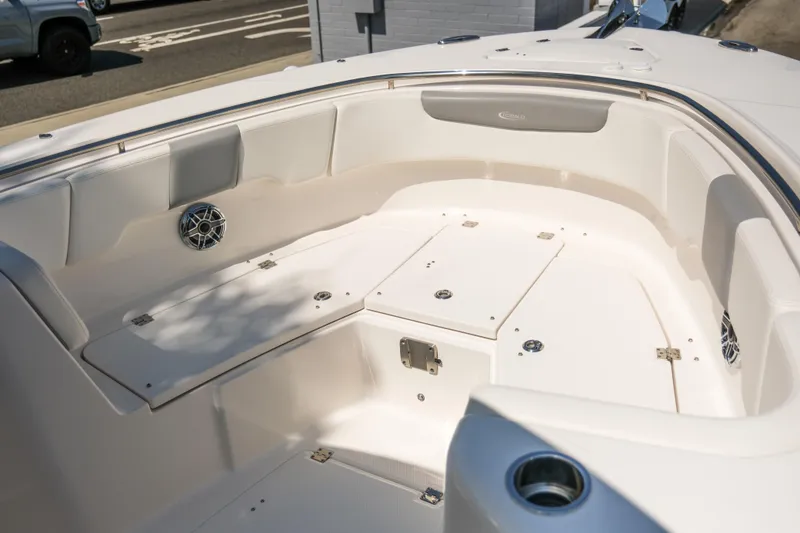 Slide: The Image of 2023 Robalo R302 Center Console boat interior with seating and storage compartments. - 12
