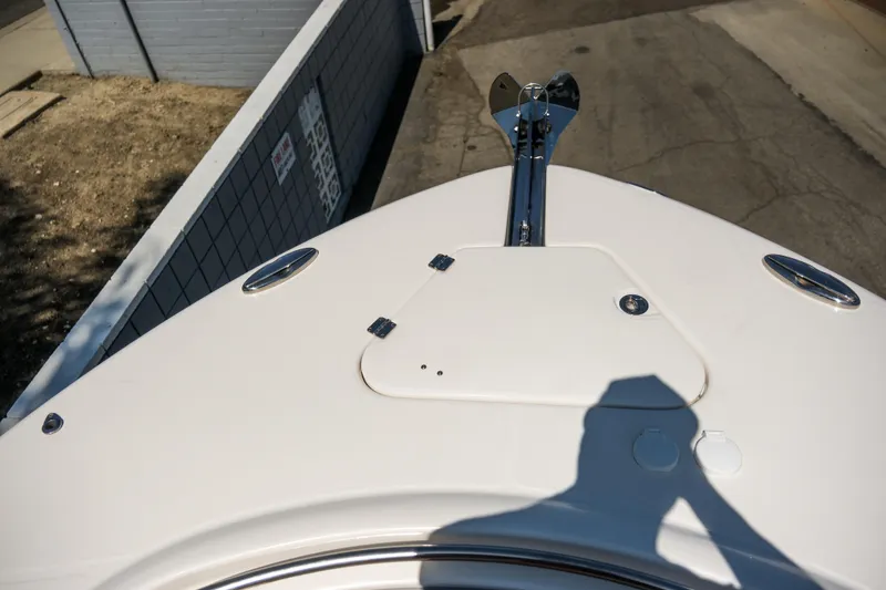 Slide: The Image of 2023 Robalo R302 Center Console boat bow with anchor and storage hatch. - 13