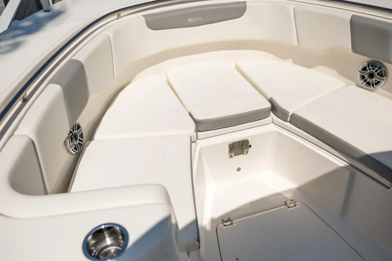 Slide: The Image of 2023 Robalo R302 Center Console boat interior with cushioned seating and speakers. - 15