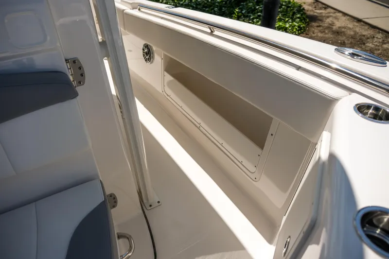Slide: The Image of 2023 Robalo R302 Center Console interior with sleek seating and storage compartment. - 19