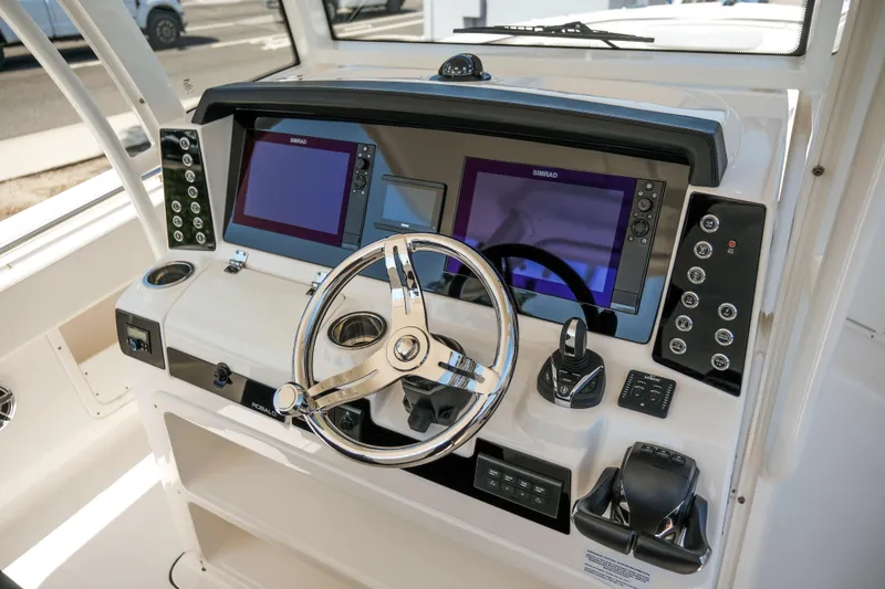Slide: The Image of 2023 Robalo R302 Center Console dashboard with dual Simrad displays and modern controls. - 20