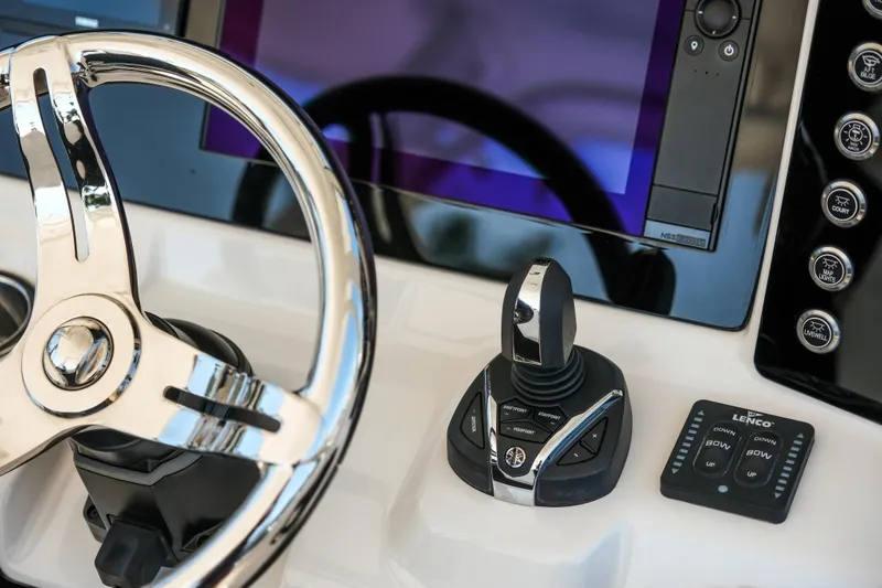 Slide: The Image of 2023 Robalo R302 Center Console steering wheel and control panel close-up. - 21