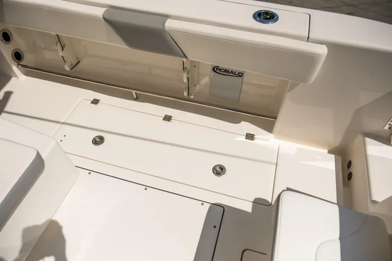 Slide: The Image of 2023 Robalo R302 Center Console boat interior with seating and storage compartments. - 23