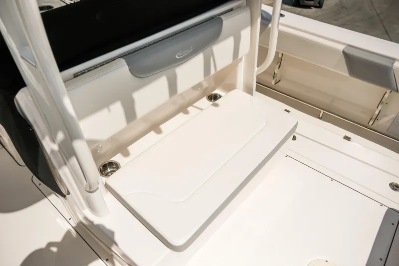 Slide: The Image of 2023 Robalo R302 Center Console boat seating area with cup holders. - 24