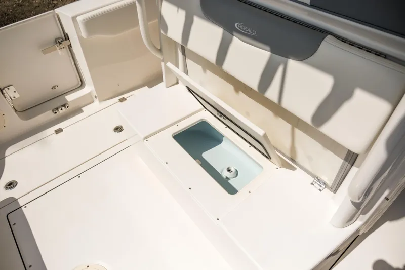 Slide: The Image of 2023 Robalo R302 Center Console boat interior with storage compartments open. - 28