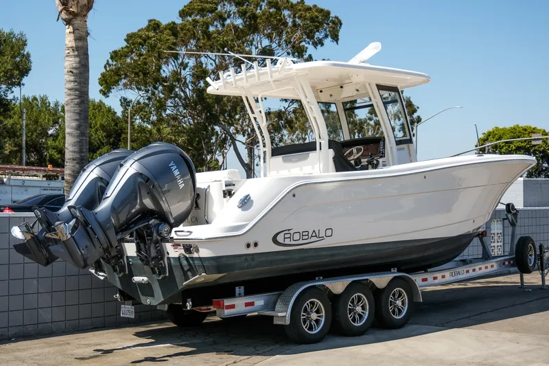 Slide: The Image of 2023 Robalo R302 Center Console boat on trailer with dual Yamaha engines. - 3