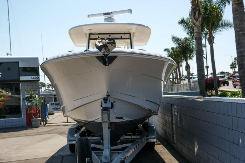 Slide: The Image of 2023 Robalo R302 Center Console boat on trailer, parked outdoors. - 5