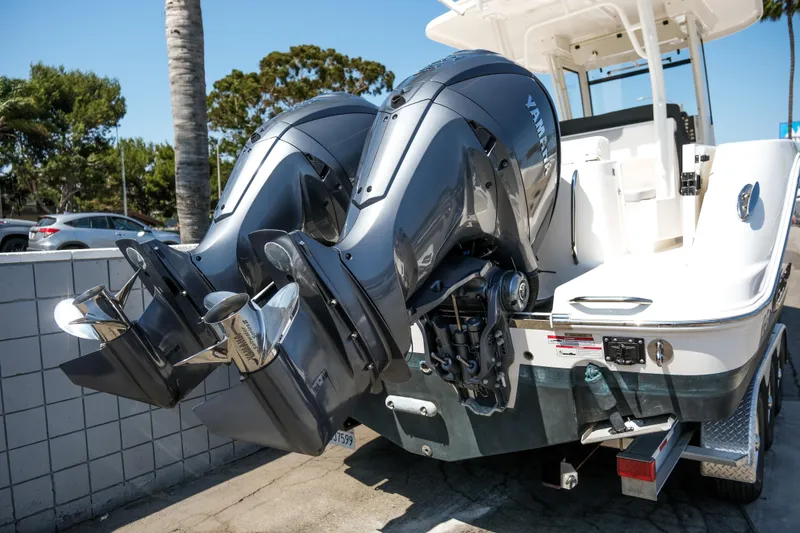 Slide: The Image of 2023 Robalo R302 Center Console boat with dual Yamaha outboard engines. - 6