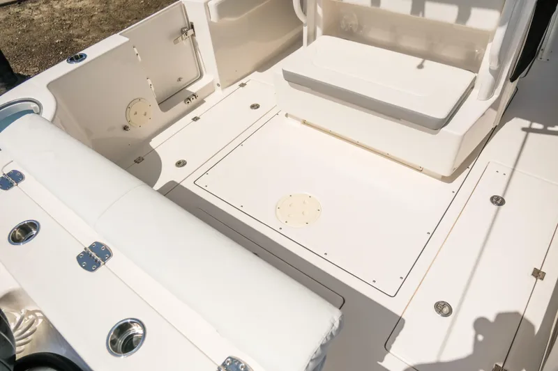 Slide: The Image of 2023 Robalo R302 Center Console boat interior with seating and storage compartments. - 8