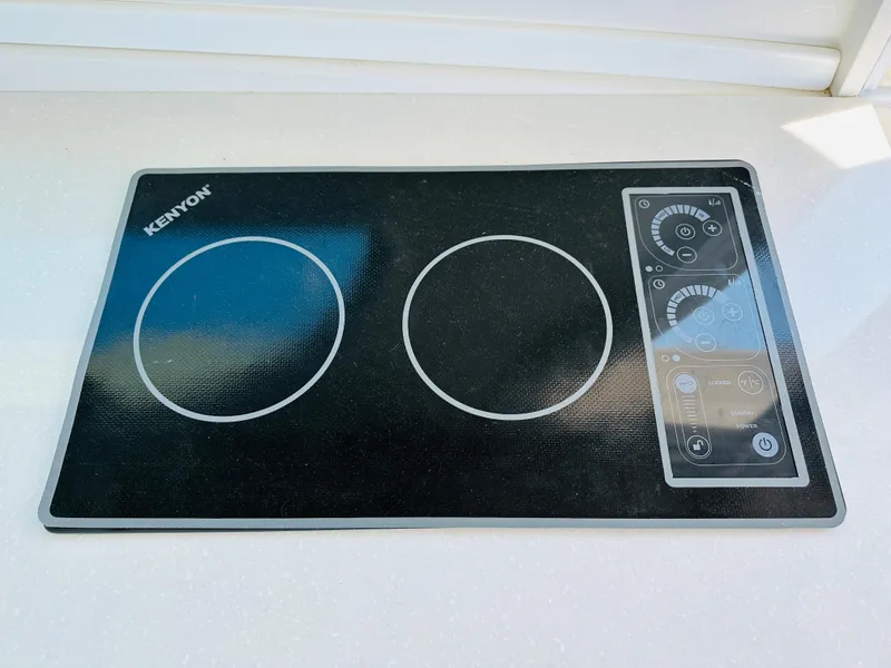 Slide: The Image of Kenyon electric cooktop on 2021 Back Cove 34O yacht kitchen counter. - 10