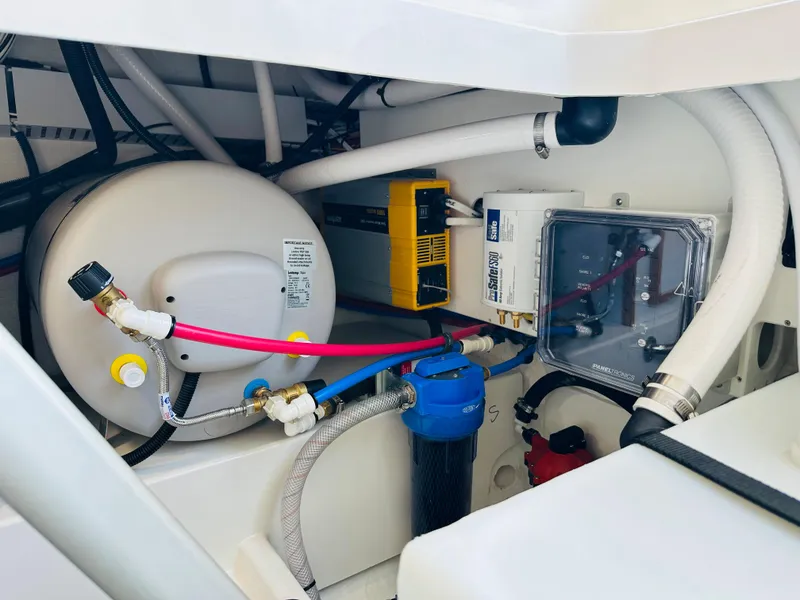 Slide: The Image of Engine compartment of a 2021 Back Cove 34O boat, showcasing various mechanical components. - 18