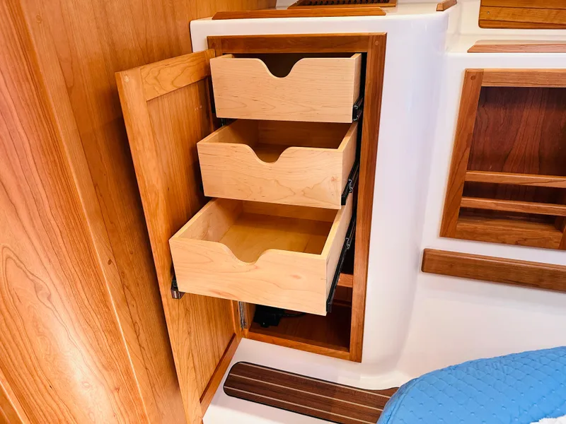 Slide: The Image of Wooden storage drawers in a 2021 Back Cove 34O boat interior. - 23