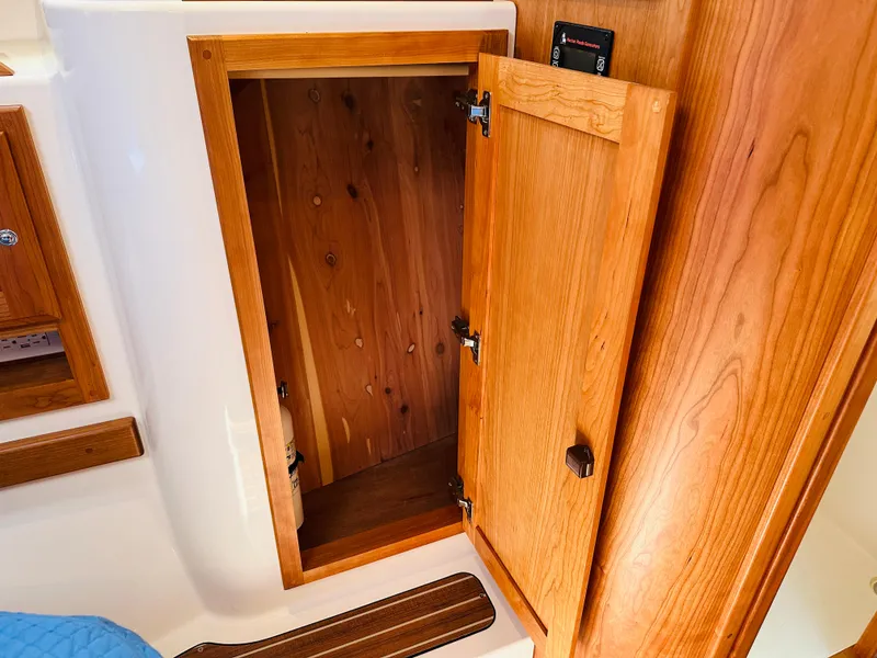 Slide: The Image of Open wooden cabinet on 2021 Back Cove 34O boat interior. - 24