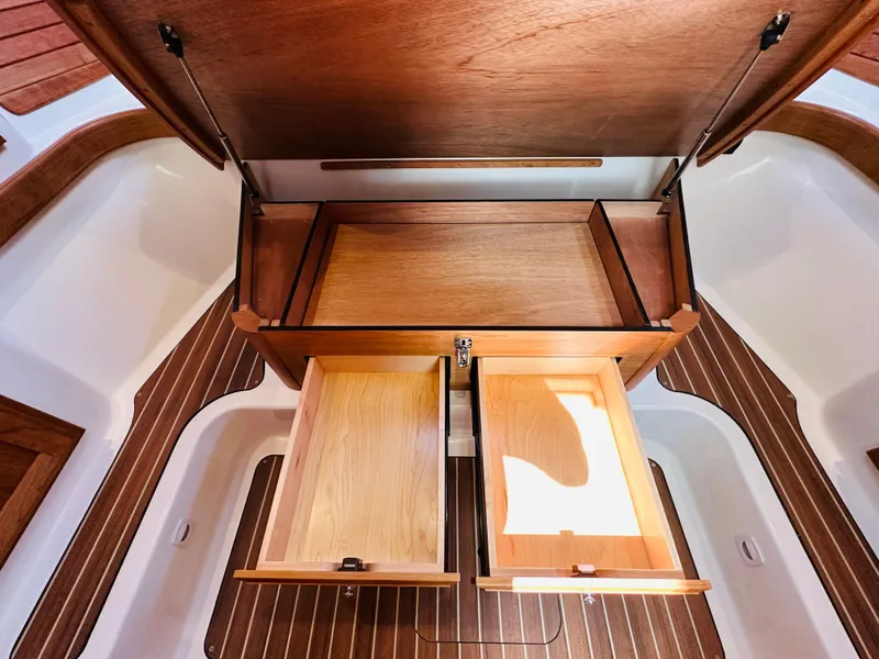 Slide: The Image of Interior view of 2021 Back Cove 34O boat with open wooden storage compartments. - 25