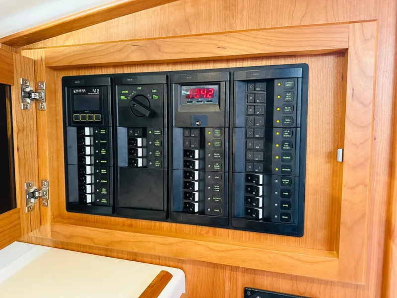 Slide: The Image of Electrical panel on 2021 Back Cove 34O boat, featuring switches and digital display. - 27