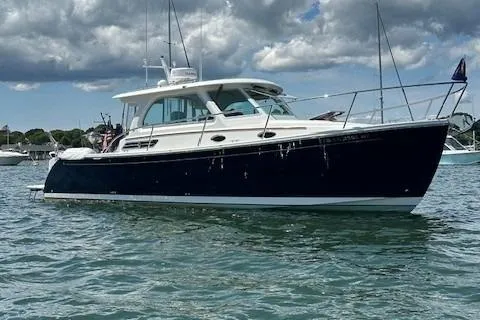 Slide: The Image of 2021 Back Cove 34O boat on water under cloudy sky. - 3
