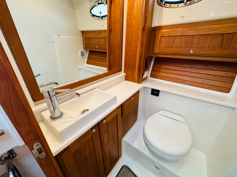 Slide: The Image of 2021 Back Cove 34O yacht bathroom with wooden cabinetry and modern fixtures. - 31