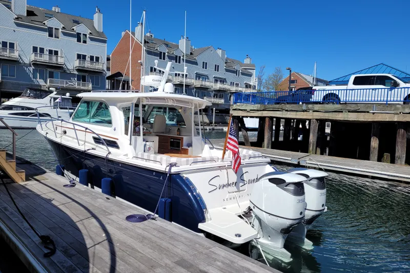 Slide: The Image of 2021 Back Cove 34O boat docked in marina with waterfront buildings. - 5
