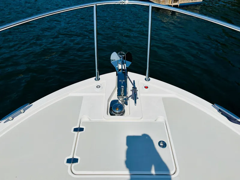 Slide: The Image of Bow of 2021 Back Cove 34O boat with anchor, on calm water. - 8