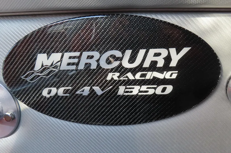 Slide: The Image of Carbon fiber Mercury Racing QC4V 1350 emblem on MTI 44, 2005 model. - 12
