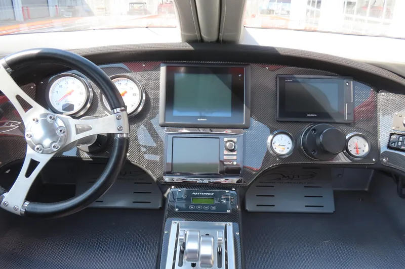 Slide: The Image of Dashboard of a 2005 MTI 44 boat with gauges and navigation screens. - 13