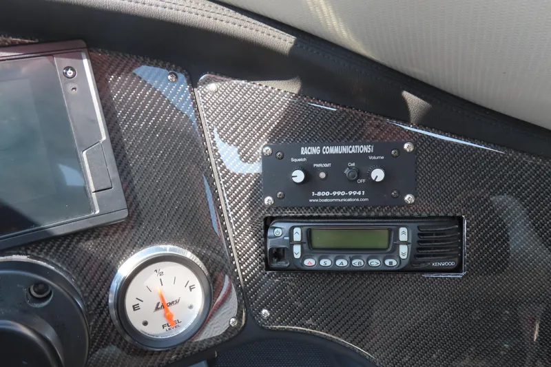 Slide: The Image of Dashboard of a 2005 MTI 44 boat with communication controls and fuel gauge. - 16