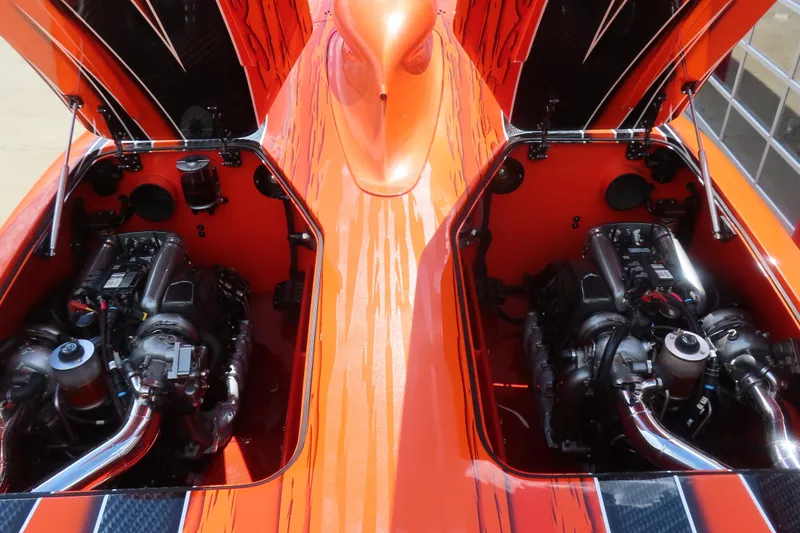 Slide: The Image of Twin engines in a 2005 MTI 44 powerboat, featuring vibrant orange and black design. - 17