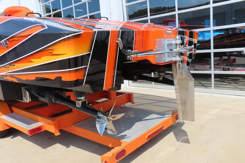 Slide: The Image of Orange MTI 44 speedboat on trailer, showcasing sleek design and propeller, 2005 model. - 5