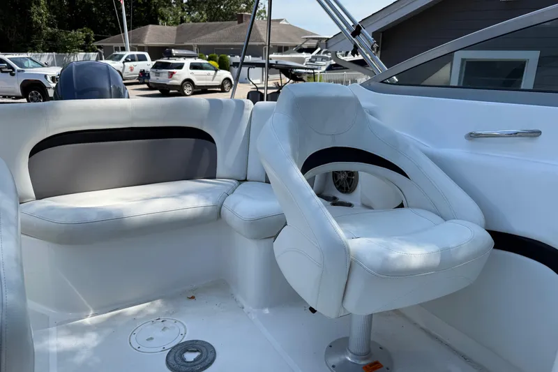 Slide: The Image of 2016 Hurricane SunDeck 2200 DC OB boat interior with white seating and modern design. - 12