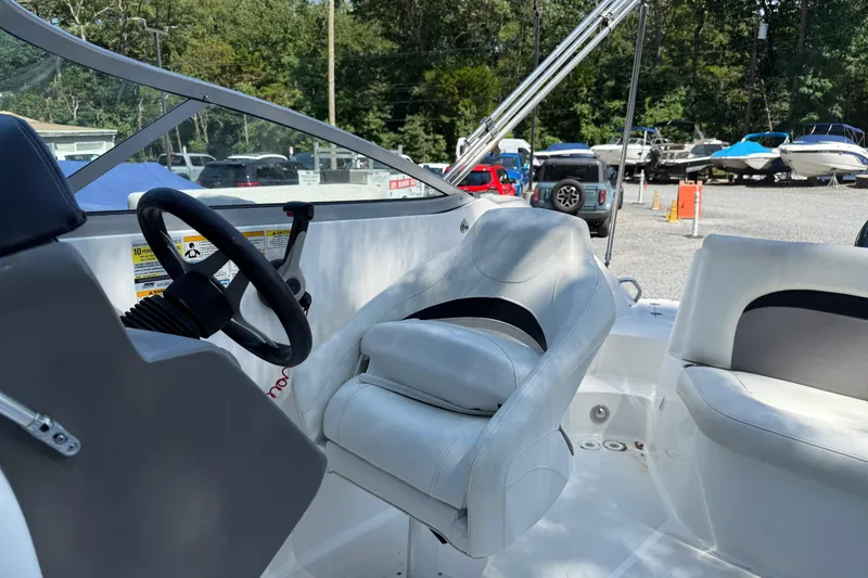 Slide: The Image of 2016 Hurricane SunDeck 2200 DC OB boat interior with steering wheel and seating. - 13