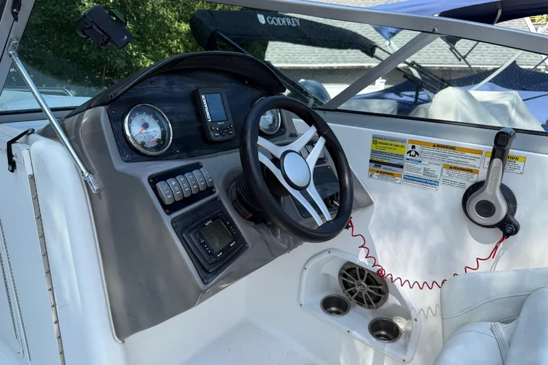 Slide: The Image of 2016 Hurricane SunDeck 2200 DC OB boat dashboard with steering wheel and controls. - 14