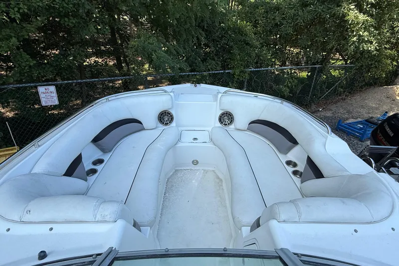 Slide: The Image of 2016 Hurricane SunDeck 2200 DC OB boat interior with white seating and cup holders. - 17