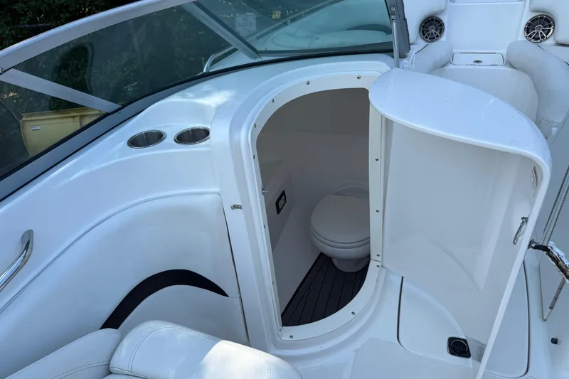 Slide: The Image of 2016 Hurricane SunDeck 2200 DC OB boat interior with open restroom door. - 19